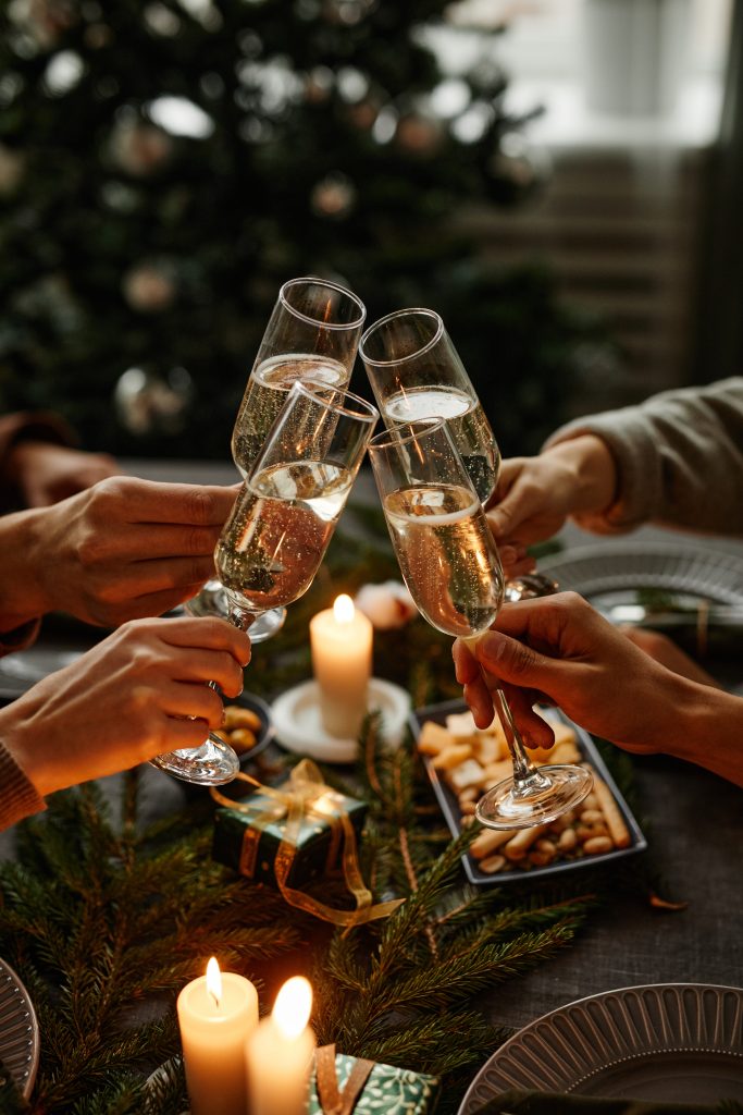 clinking glasses at christmas dinner